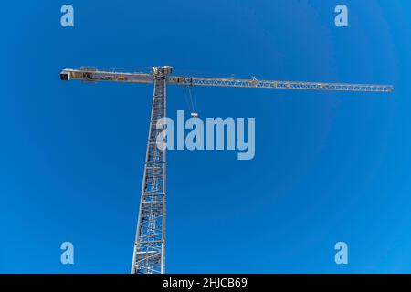 Los Angeles, CA, USA - January 26, 2022: Tower cranes soar above a construction site in Los Angeles, CA. Stock Photo