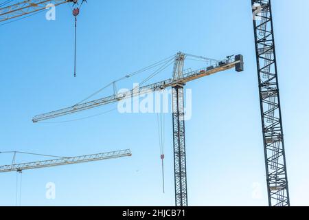 Los Angeles, CA, USA - January 26, 2022: Tower cranes soar above a construction site in Los Angeles, CA.