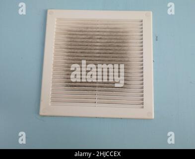 Dirty air ventilation grill hatch. dusty clogged filter. Background lattice of exhaust hood. Stock Photo