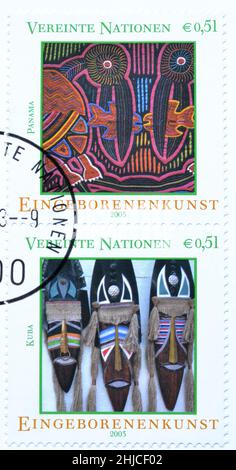 Cancelled postage stamp printed by United Nations, that shows Masks at Havana Marketplace, Cuba, Tarabuco woven cloth, Bolivia, circa 2003. Stock Photo