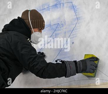 Beijing, China. 28th Jan, 2022. An ice maker works over a stencil paper of a sub-glacial Beijing 2022 logo on the track at the Yanqing National Sliding Center ahead of the 2022 Winter Olympics in the Yanqing district of Beijing, China, Jan. 28, 2022. Credit: Sun Fei/Xinhua/Alamy Live News Stock Photo