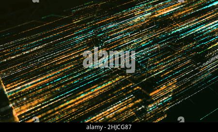 Green and yellow abstract dotted lines flying fast. Glowing beams of energy or flowing data, optical fiber on black background. Stock Photo