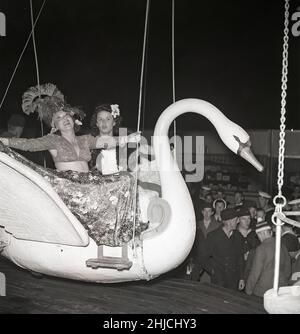 Amusement park in the 1940s. Women are enjoying themselves in a swinging merry go round, looking af they enjoy it. Sweden 1944. Kristoffersson ref G139-3 Stock Photo