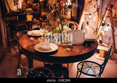 Served table for Christmas dinner in cozy restaurant Stock Photo