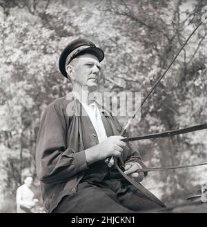 Horse and carriage. A man in uniform is sitting ready in the carriage prepared with the whip and holding the reins that he controls the horse with. A coachman also used different sounds to make the horse start and stop. Sweden 1947 Kristoffersson ref AD17-8 Stock Photo