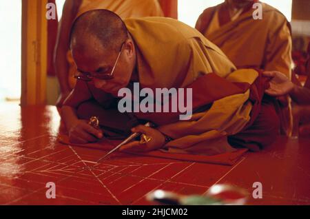 The Dalai Lama, political and spiritual leader of the Tibetan people, drawing the first line of a sand mandala in Tibet. Tenzin Gyatso (born 1935) is the 14th and current Dalai Lama. He was awarded the Nobel Peace Prize in 1989. Stock Photo