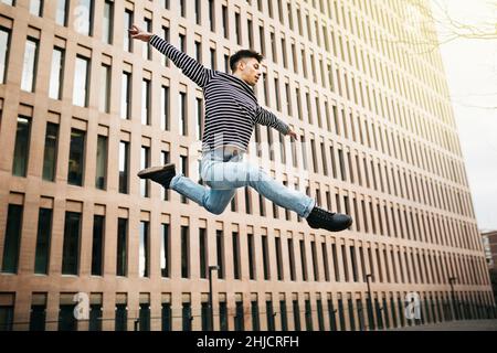 Young man jumping and dancing on the street Stock Photo