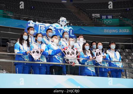 Beijing, China. 26th Jan, 2022. Volunteers and a staff member pose for a photo at the National Indoor Stadium in Beijing, China, Jan. 26, 2022. Credit: Du Yu/Xinhua/Alamy Live News Stock Photo