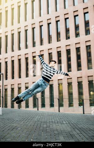 Young man jumping on the street Stock Photo