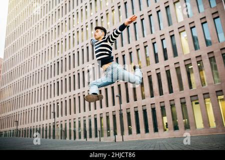Young man jumping on the street Stock Photo