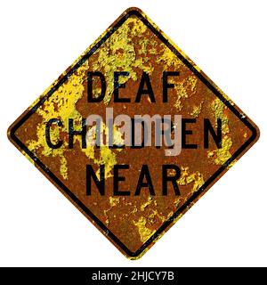 Old rusty American road sign - Deaf children near, California Stock Photo