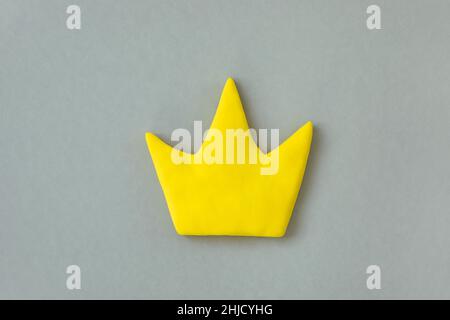 Simple 3d yellow crown symbol on gray background. Concept of win and success, top rank quality status. Stock Photo