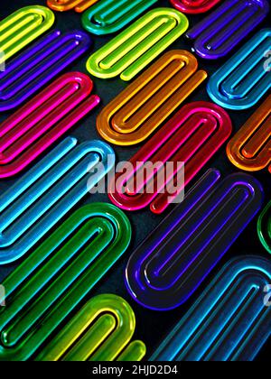 Acrylic paper clips on black background Stock Photo