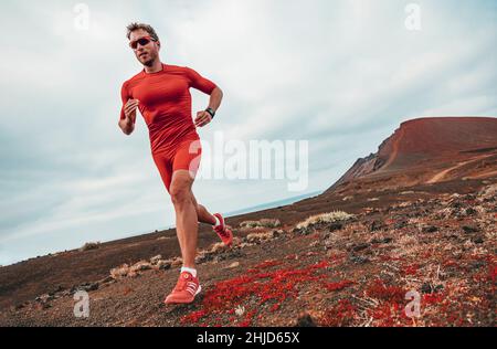 Running marathon man runner sport athlete training ultra running on long distance endurance trail race wearing compression clothes, sunglasses Stock Photo