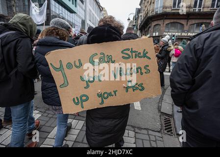 (EDITOR'S NOTE: Image contains profanity)A protester holds a placard while marching through Belliard street during the demonstration. The end of Sunday's demonstration in the Belgium city of Brussels and the heart of the European Union was marred by a small minority only bent on violence. As 50,000 plus demonstrators from all parts of Europe participated in an anti-government coronavirus measures protest which passed without incident. A violent minority clad in black, overran the European District, they vandalized cars, stones were catapulted and thrown and road signs uprooted, the front of th Stock Photo