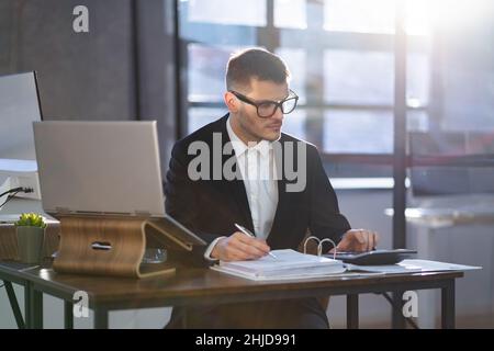 Professional Financial Accountant Manager Using Laptop For Taxes And Audit Stock Photo