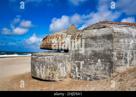 Old concrete bunkers from WWII line the beaches on the west coast of Denmark. The bunkers are part of The Atlantic Wall that was an extensive system o Stock Photo