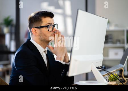 Pondering Thinking Businessman Using Office Computer. Contemplative Man Stock Photo
