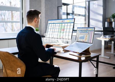 Analyst Working With Spreadsheet Business Data On Computer Stock Photo