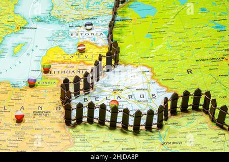 Concept of common border Russia and Belarus. Fence separating from European countries NATO Latvia Lithuania and Estonia. Close up picture on a colorfu Stock Photo