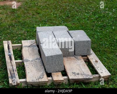 bricks lie on a pallet in the village, in summer Stock Photo