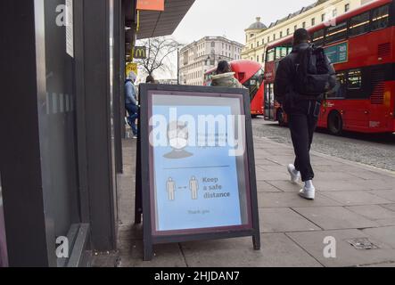 London, UK. 28th Jan, 2022. A sign outside a store in Central London encourages people to continue to wear face masks if they can and to maintain social distancing, as England ends mandatory face coverings in indoor public spaces. (Photo by Vuk Valcic/SOPA Images/Sipa USA) Credit: Sipa USA/Alamy Live News Stock Photo