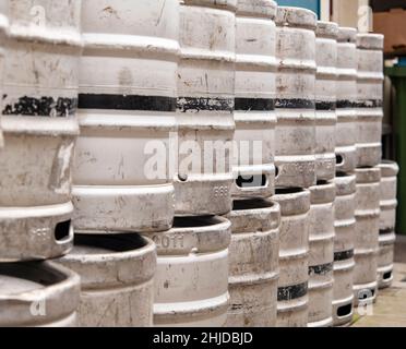 Aluminum beer barrels stacked on top of each other Stock Photo