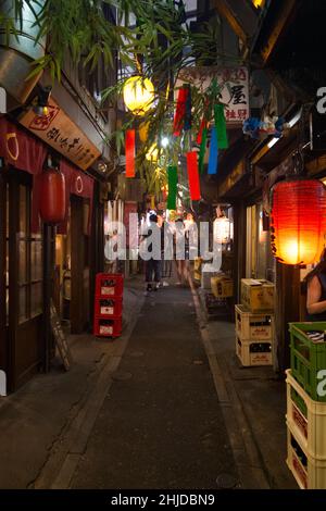 View of narrow alley of Omoide Yokocho in Shinjuku, Tokyo at sunset Stock Photo