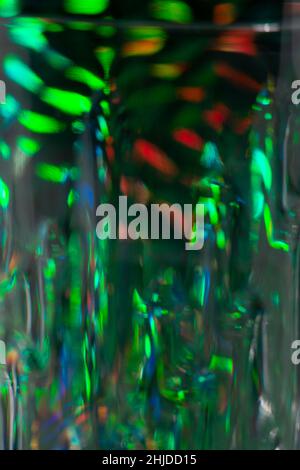 Abstract blurred defocused dark green background with light leaks and reflections. Stock Photo