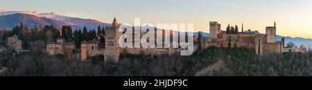 Palace and fortress complex Alhambra with Comares Tower, Palacios Nazaries and Palace of Charles V during sunset in Granada, Andalusia, Spain Stock Photo