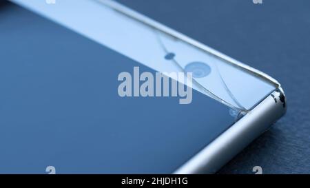 Crack on the smartphone screen macro photography. Broken touchscreen of the phone. Repair of phones and gadgets service. Stock Photo