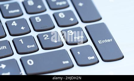 Keys on laptop keyboard macro photography. Numeric keypad close-up. Office work concept. Counting the economic efficiency of a business or startup con Stock Photo