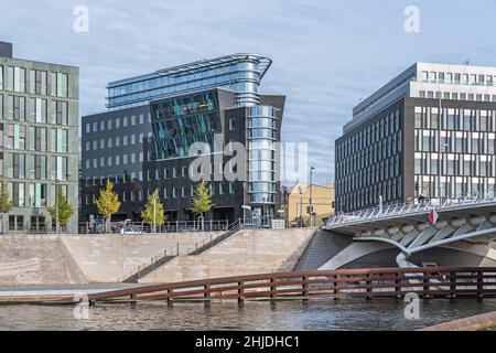 Berlin, Germany - October 18, 2021: One of the banks of the river Spree Kapelle Ufer with  buildings of the SoftEd Systems with its reflecting facade Stock Photo