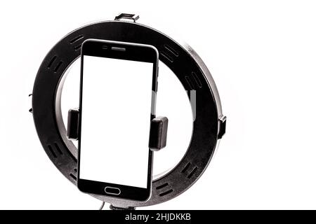Ring Light template tripe with isolated white background, cellphone filming vertical standing with space for text or photo. Stock Photo