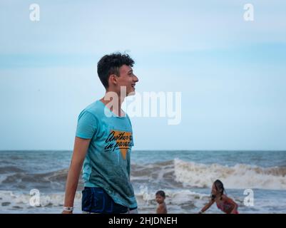 Palomino, Dibulla, La Guajira, Colombia - December 4 2021: A Young Latin Man Smiles in the Beach Stock Photo