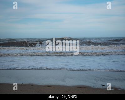 White Spume Known as Sea, Ocean or Beach Foam Created by the Agitation of Seawater in Palomino, Dibulla, La Guajira, Colombia Stock Photo