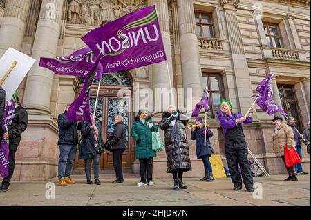 Glasgow, UK. 27th Jan, 2022. Members of the workers union Unison are seen picketing outside Glasgow City Chambers during the protest.Following the October 23rd protest in 2018, female employees of Glasgow City Council are still having issues with receiving the money owed to them, with some even saying the council is refusing to pay up, the payout tops £500m. Credit: SOPA Images Limited/Alamy Live News Stock Photo