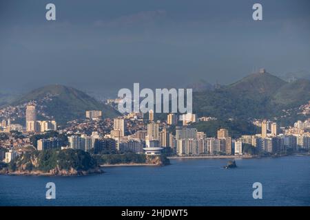 Niteroi, Rio de Janeiro, Brazil. Elevated view of downtown Niteroi. Oscar Niemeyer's MAC gallery (foreground) Icarai beach & Morro do Estado favela Stock Photo