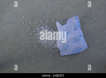 Desiccant silica gel on wooden background Stock Photo