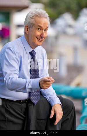 Smiling businessman pointing finger at camera Stock Photo