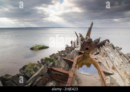View of an old wrecked wooden boat on the beach of the Baltic Sea, Lahemaa, Estonia