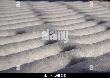 Full frame closeup abstract texture background of snow designs on a wooden deck Stock Photo