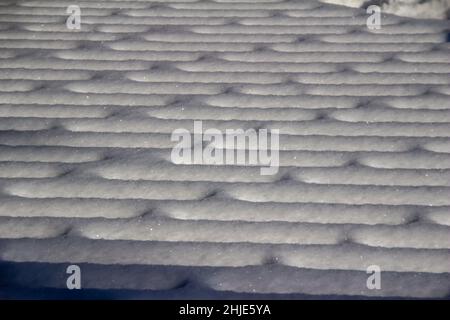Full frame closeup abstract texture background of snow designs on a wooden deck Stock Photo