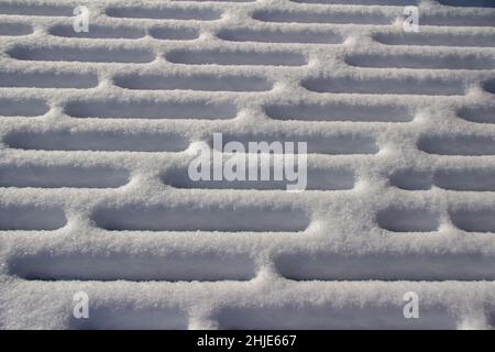 Full frame closeup abstract texture background of snow designs on a wooden deck Stock Photo
