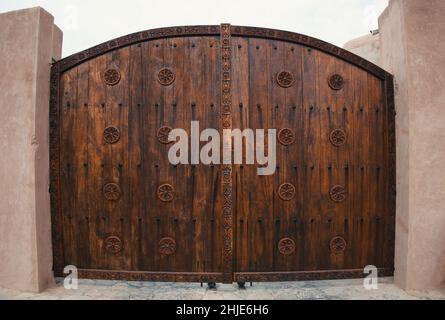 Wooden door with arch in Oman - public places Stock Photo