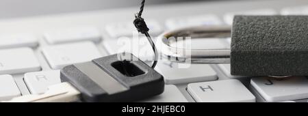 Key and lock on white computer keyboard closeup Stock Photo
