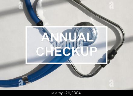Annual checkup text on photo with sthethoscope. Health and medic care concept. Year check-up. Stock Photo