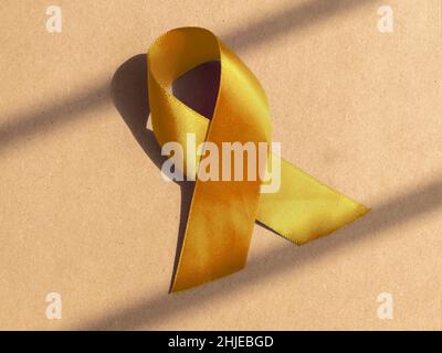 Yellow satin ribbon as medical symbolic loop. Stock Photo