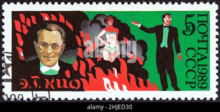 USSR - CIRCA 1989: A stamp printed in USSR from the '70th Anniversary of Soviet Circus ' issue shows E. T. Kio (illusionist) and act, circa 1989. Stock Photo