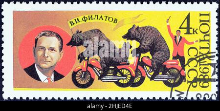 USSR - CIRCA 1989: A stamp printed in USSR shows V. I. Filatov (founder of Bear Circus) and bears on motor cycles, circa 1989. Stock Photo